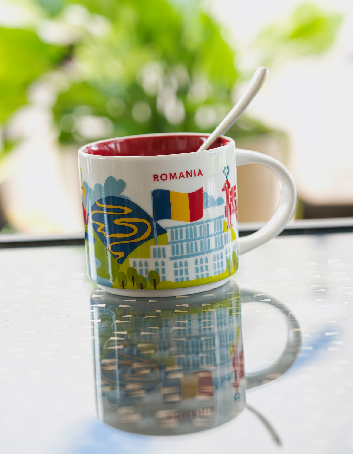 a starbucks been there romanis mug is seen on a table against a light green background